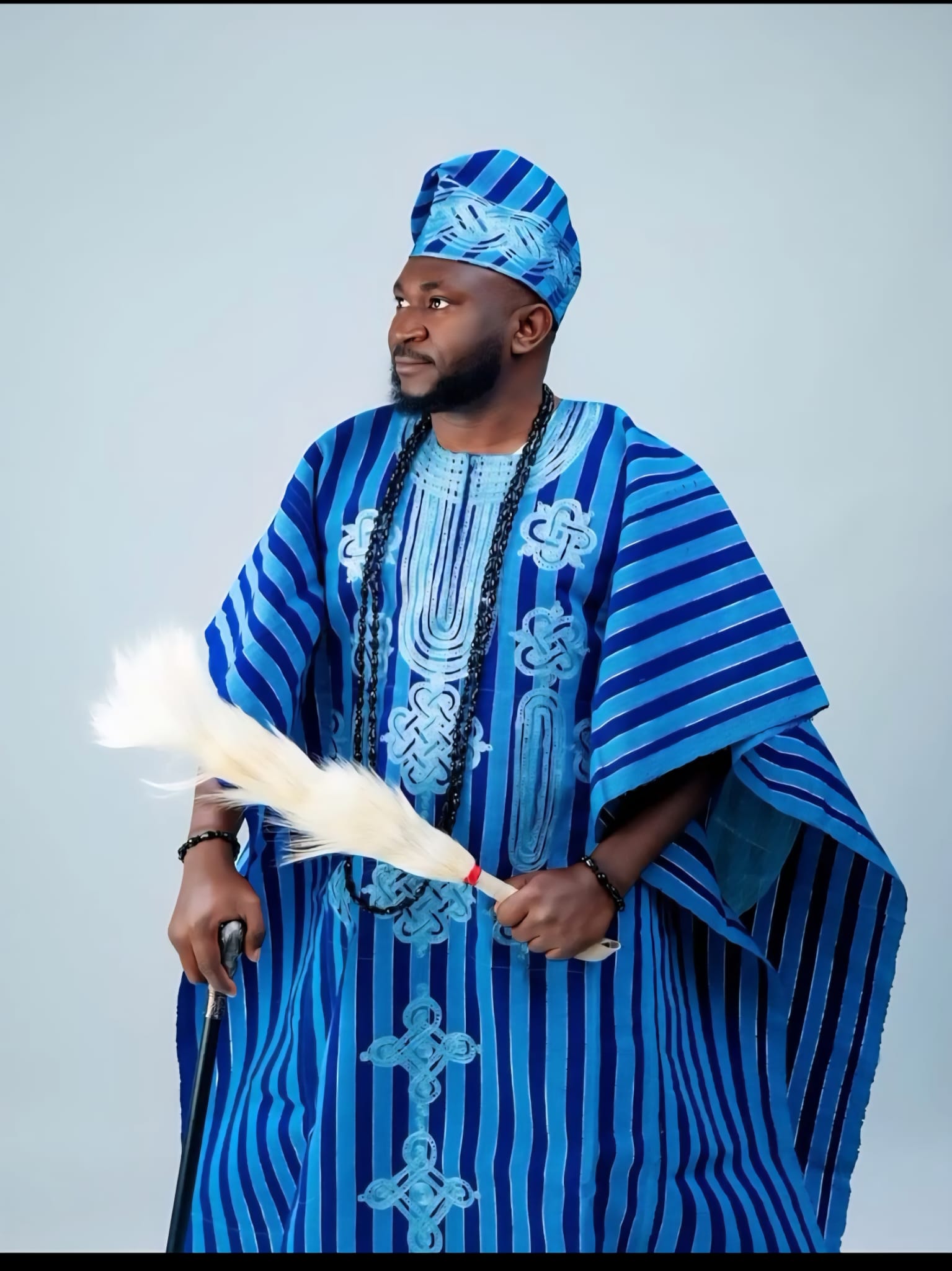 Man in embroidered agbada with fila cap