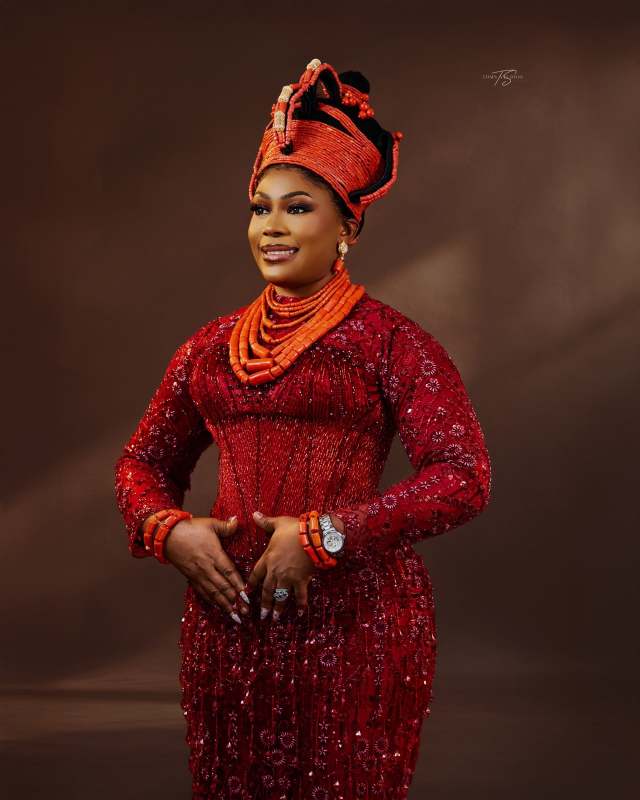 Woman in red Esan attire with coral bead headpiece