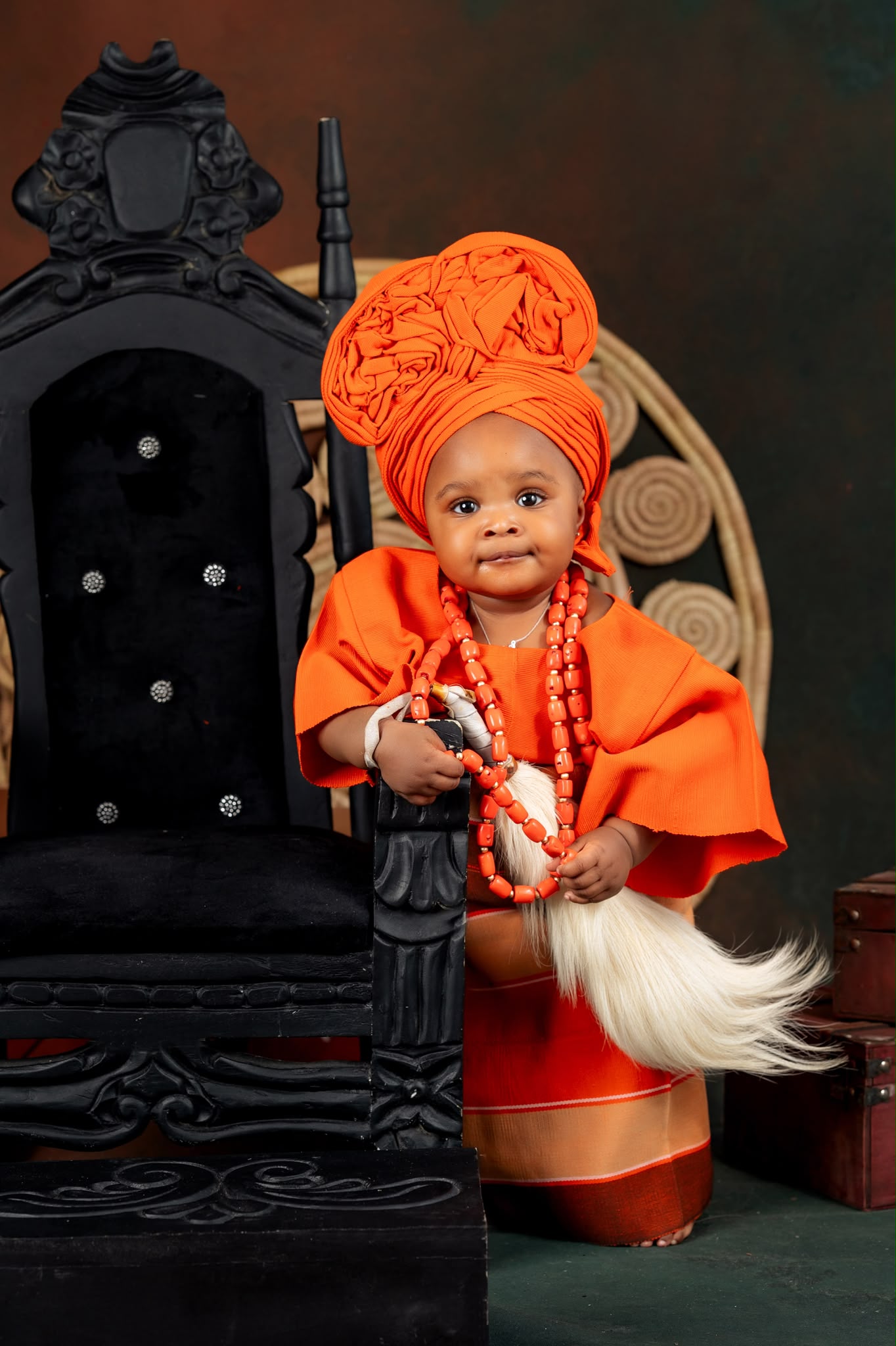 Child wearing cream and gold traditional agbada