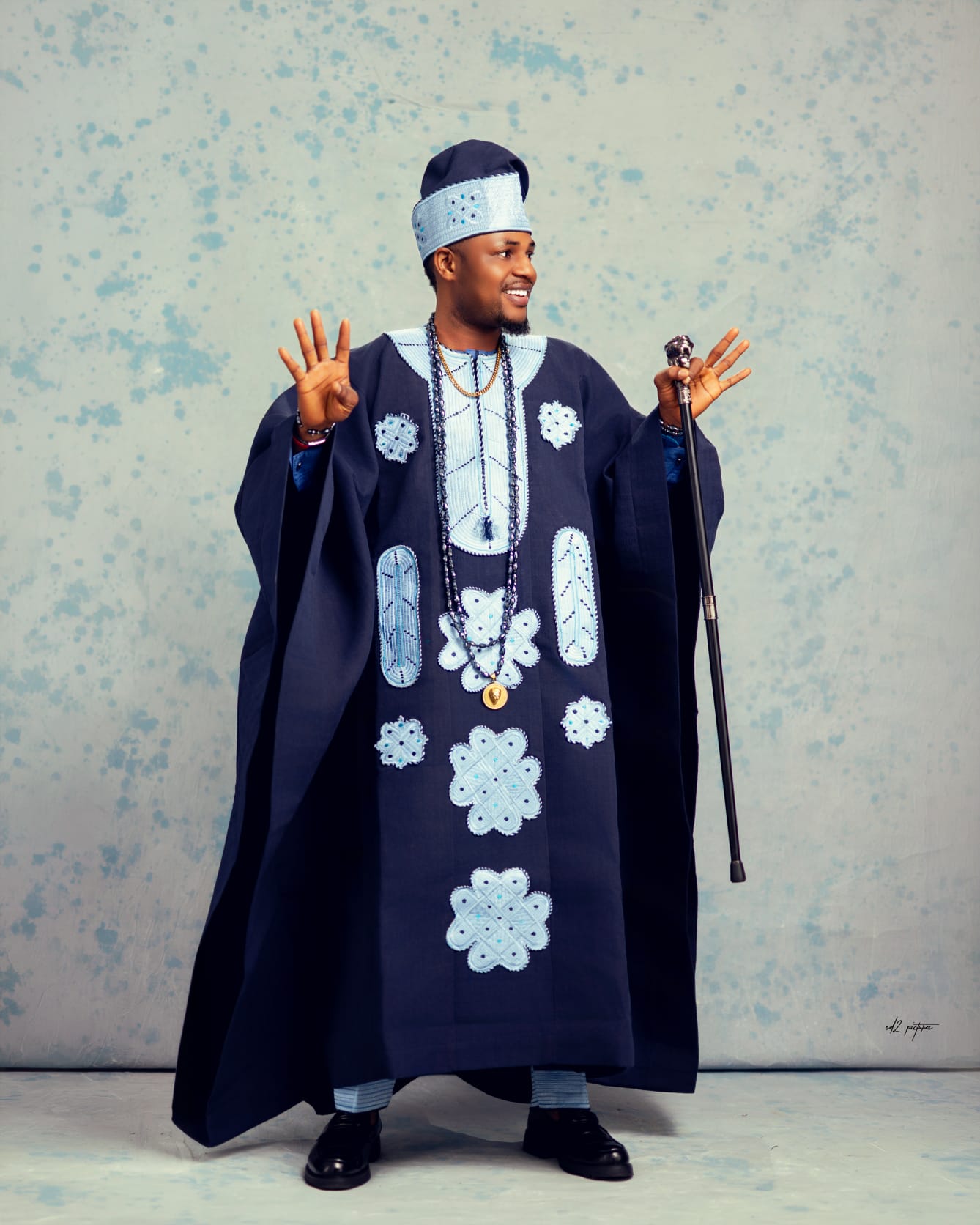 Edo groom in white wrapper with layered coral bead necklaces