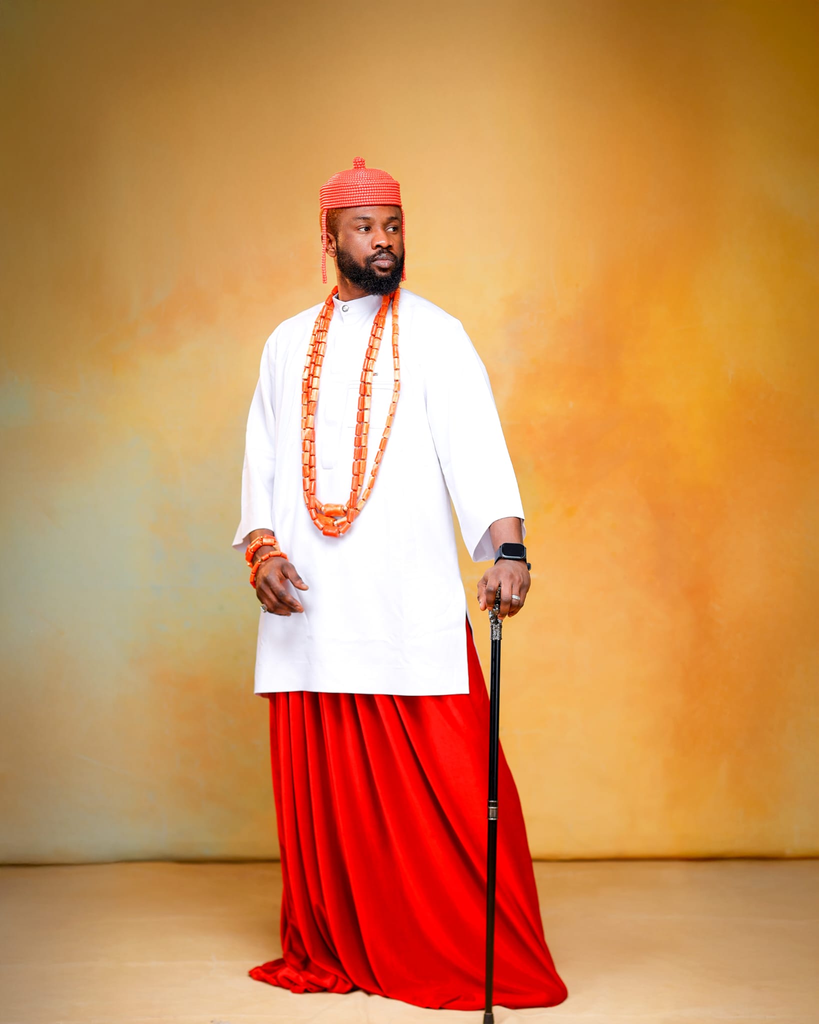 Edo groom in white wrapper with layered coral bead necklaces
