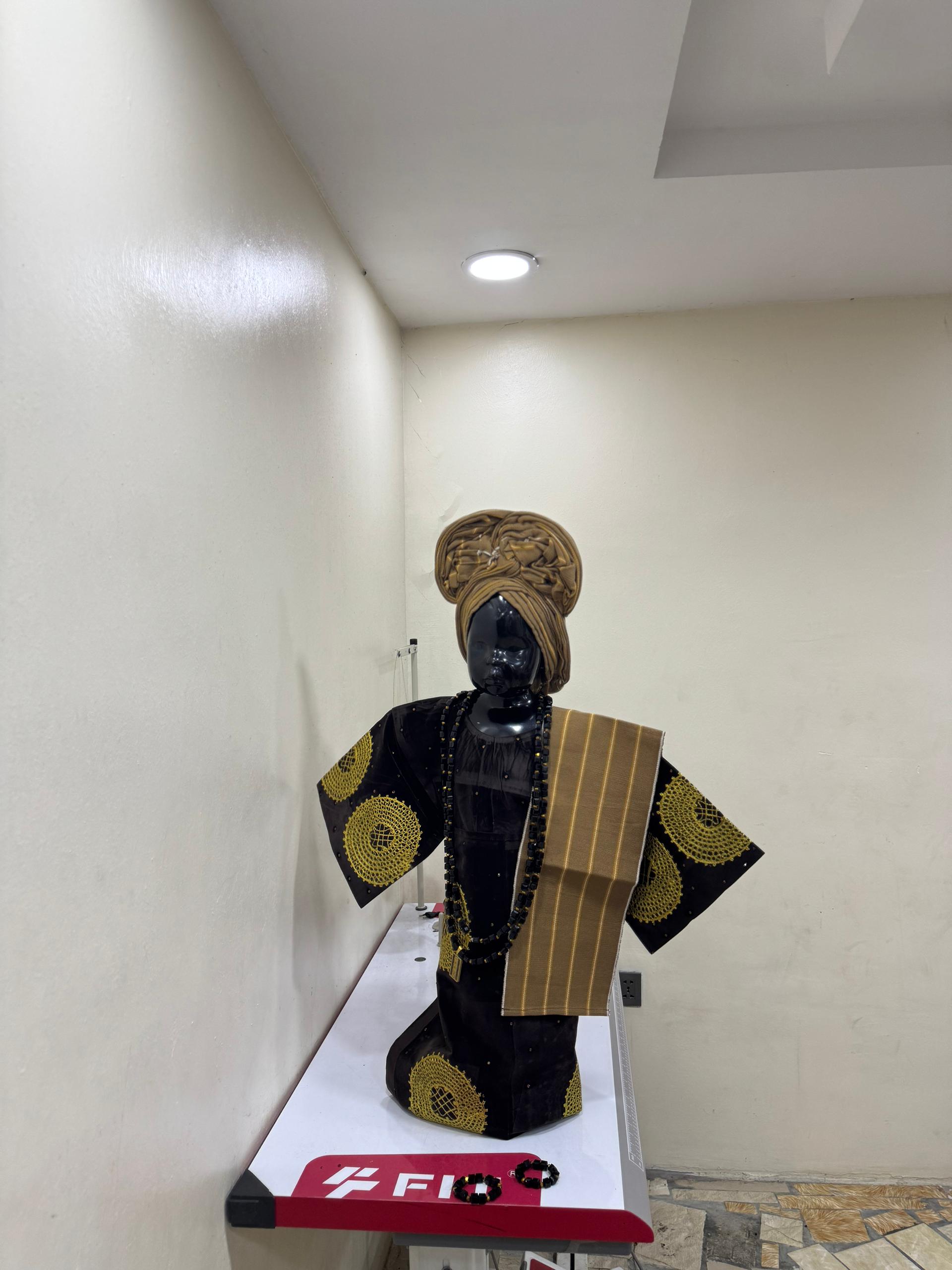 Young girl in purple and gold Aso Oke with small gele