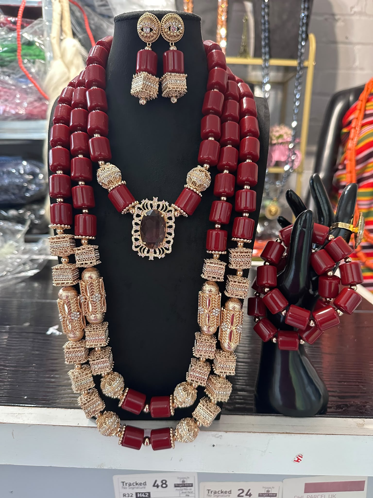 Ornate coral bead crown headpiece on a stand