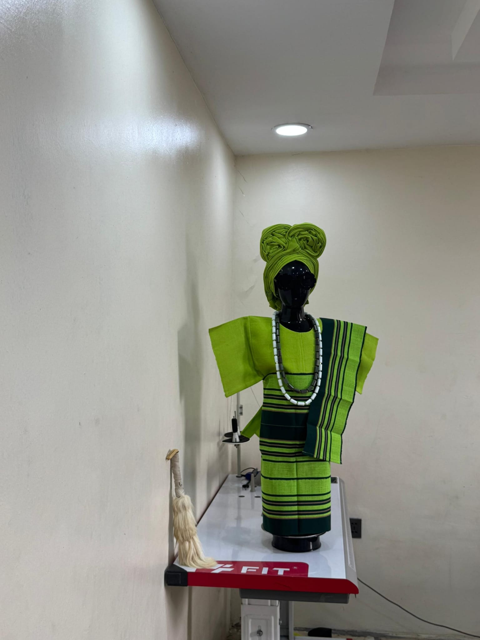 Man in ivory and gold embroidered agbada with fila cap