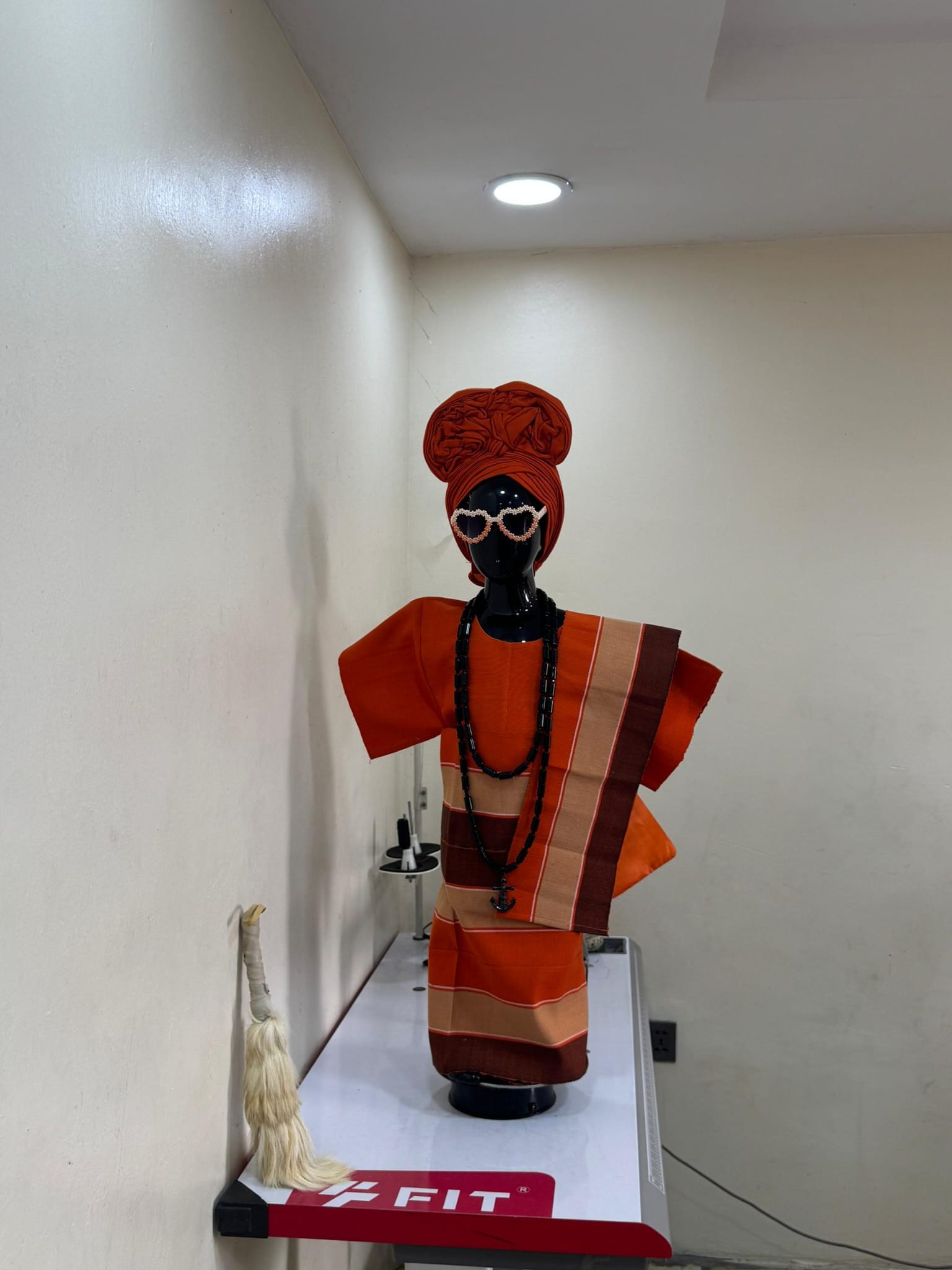 Child in cream and gold traditional agbada with cap